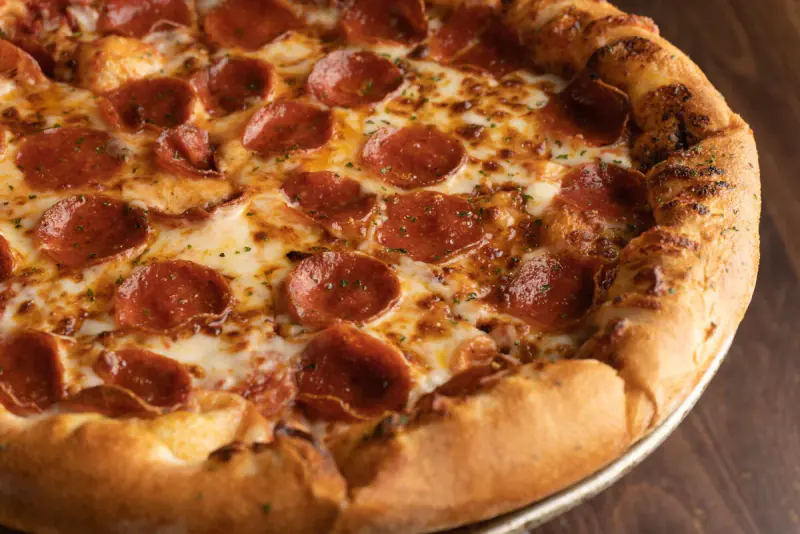 Fresh pepperoni pizza made by a Durkin's Pizza cook in McKinney