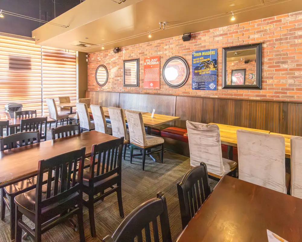 Dining room with booths and tables at Durkin&rsquo;s Pizza, 8930 State Hwy 121, McKinney, TX